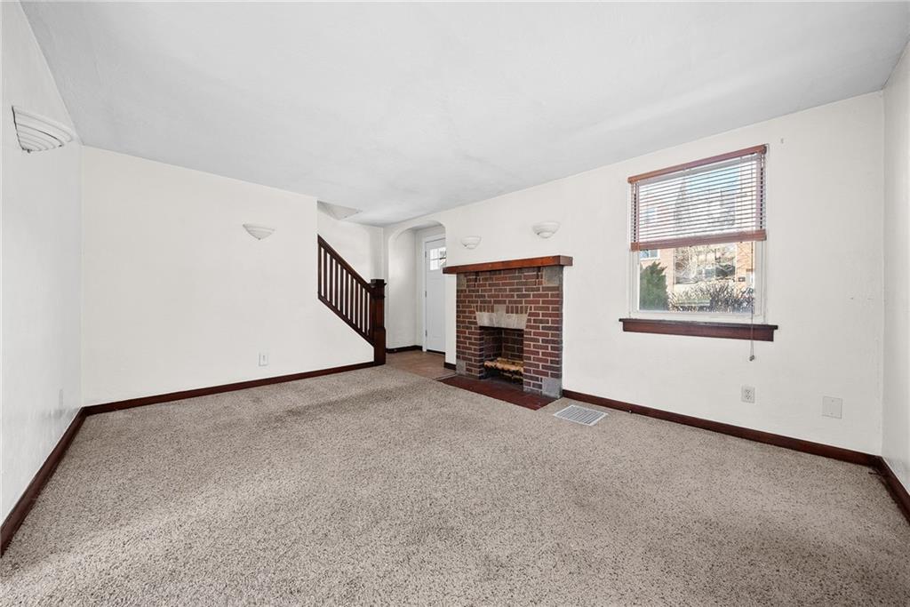 105 Kaplan Avenue Pittsburgh, PA 15227 - Photo 9 of 37 Spacious living room with fireplace and side door to new concrete patio.