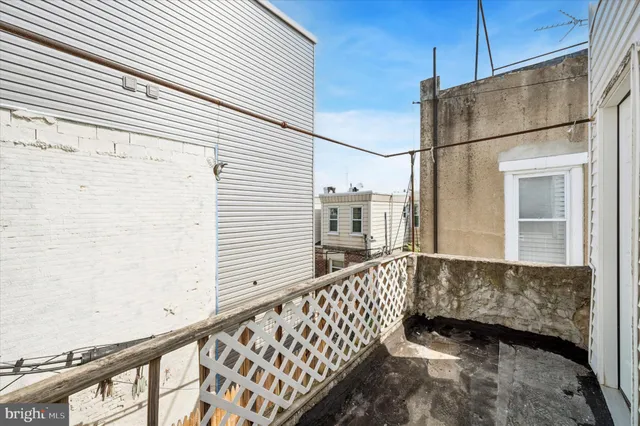 a view of a balcony with wooden fence