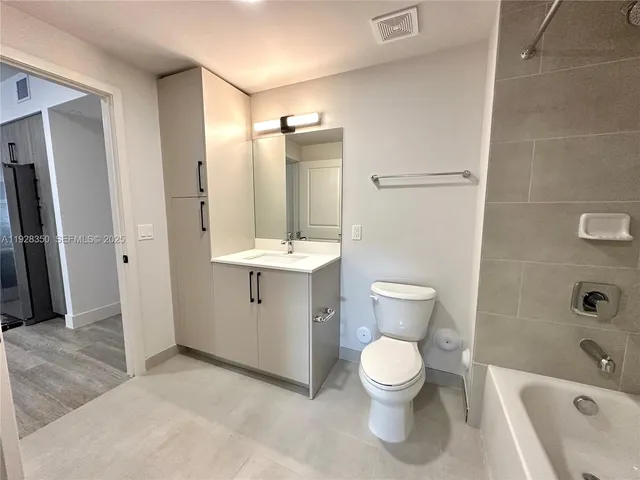 a bathroom with a toilet sink and shower