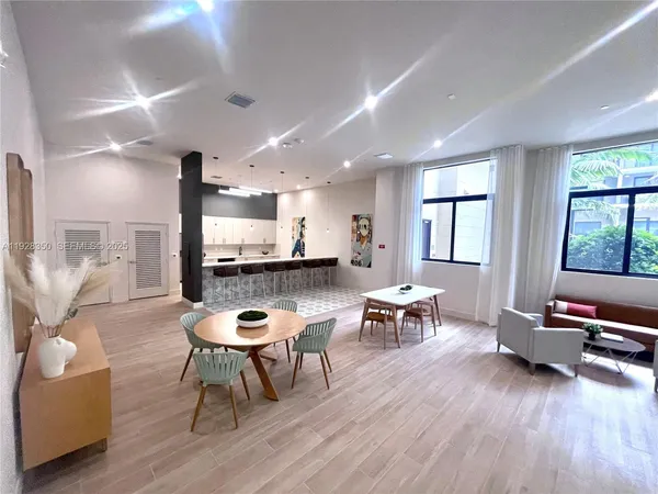 a view of a living room and kitchen with furniture