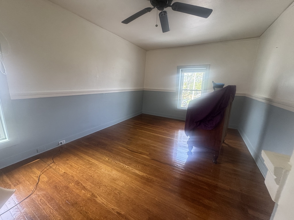 39 Belmont Street, Unit 2 Fall River, MA 02720 - Photo 5 of 10 a view of empty room with wooden floor and fan