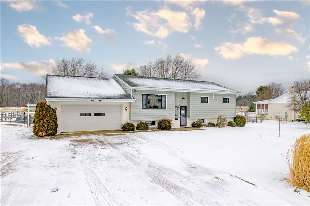 a view of a house with snow in front of it