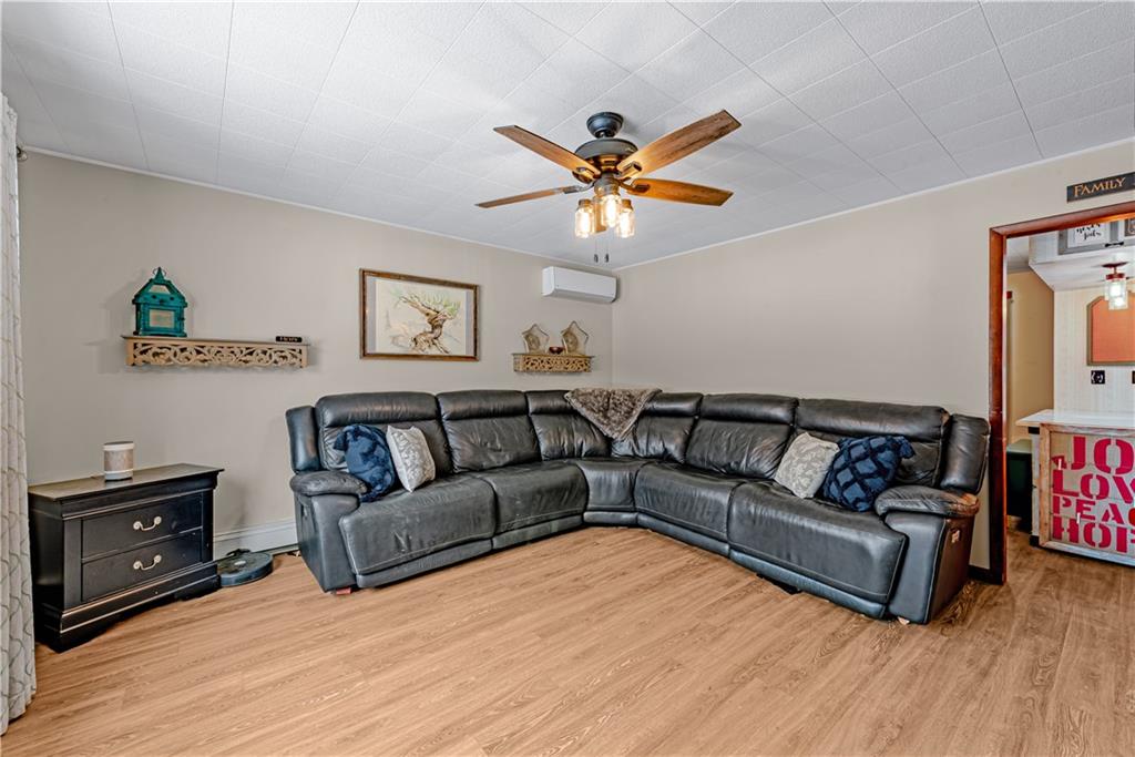 224 Kaufman Church Road Davidsville, PA 15928 - Photo 5 of 25 a living room with couches and a flat screen tv with wooden floor