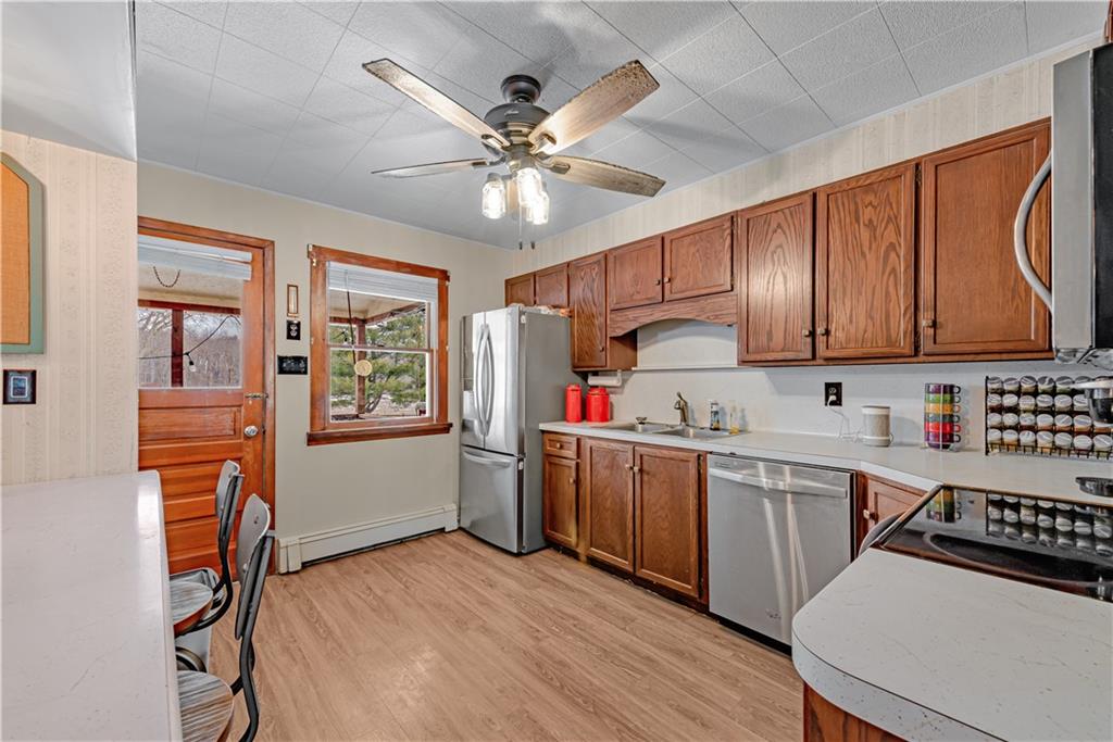 224 Kaufman Church Road Davidsville, PA 15928 - Photo 7 of 25 a kitchen with stainless steel appliances a stove a refrigerator cabinets and wooden floor