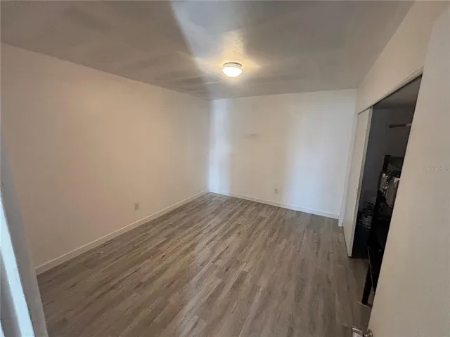 a view of a room with wooden floor and staircase