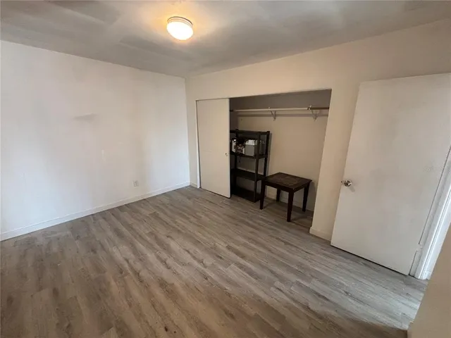 a view of a room with wooden floor and lounge chairs