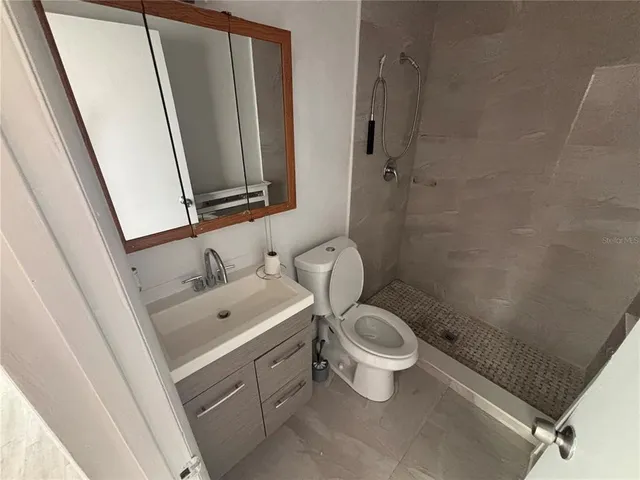 a bathroom with a toilet sink and a mirror