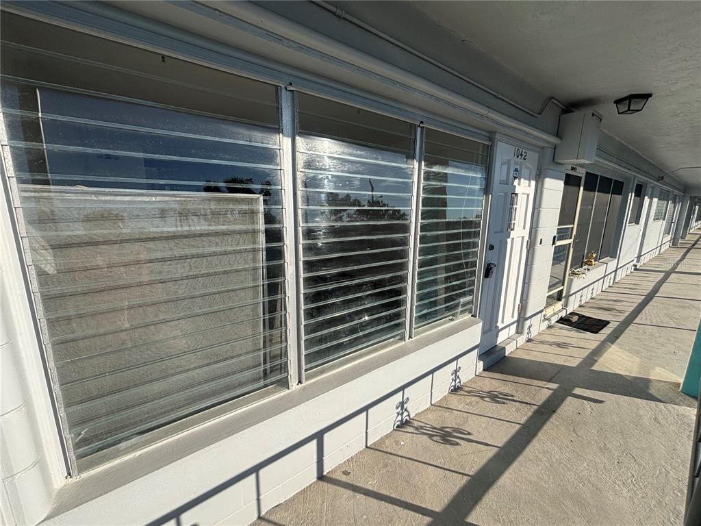 4061 55th Way North, Unit 1042 Kenneth City, FL 33709 - Photo 2 of 18 a view of rack and stairs