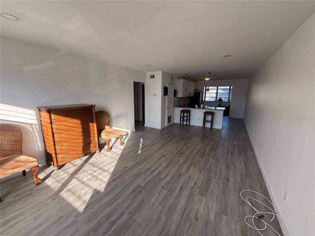 4061 55th Way North, Unit 1042 Kenneth City, FL 33709 - Photo 3 of 18 a view of a living room and dining room