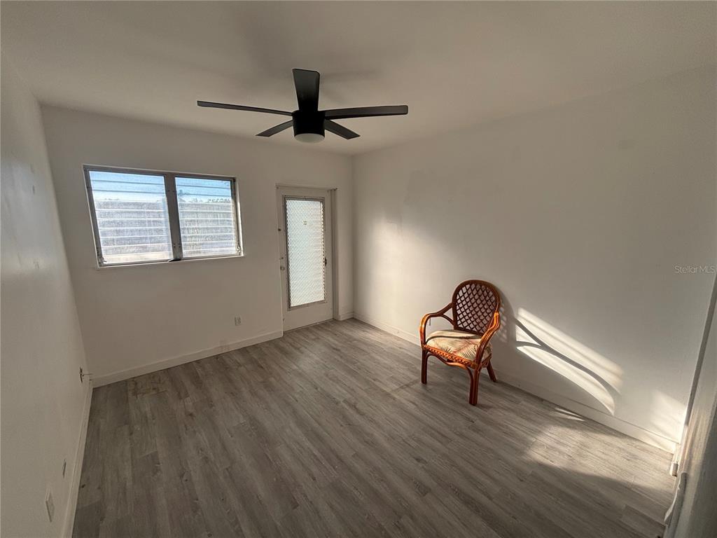 4061 55th Way North, Unit 1042 Kenneth City, FL 33709 - Photo 10 of 18 a room with a chair and a window