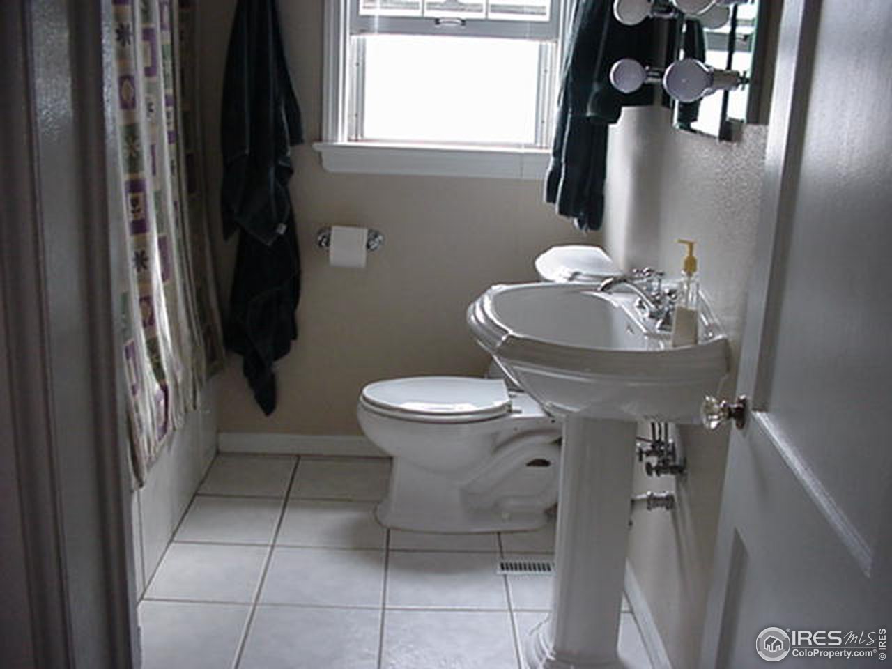 409 East Prospect Road Fort Collins, CO 80525 - Photo 6 of 10 a bathroom with a toilet sink and mirror