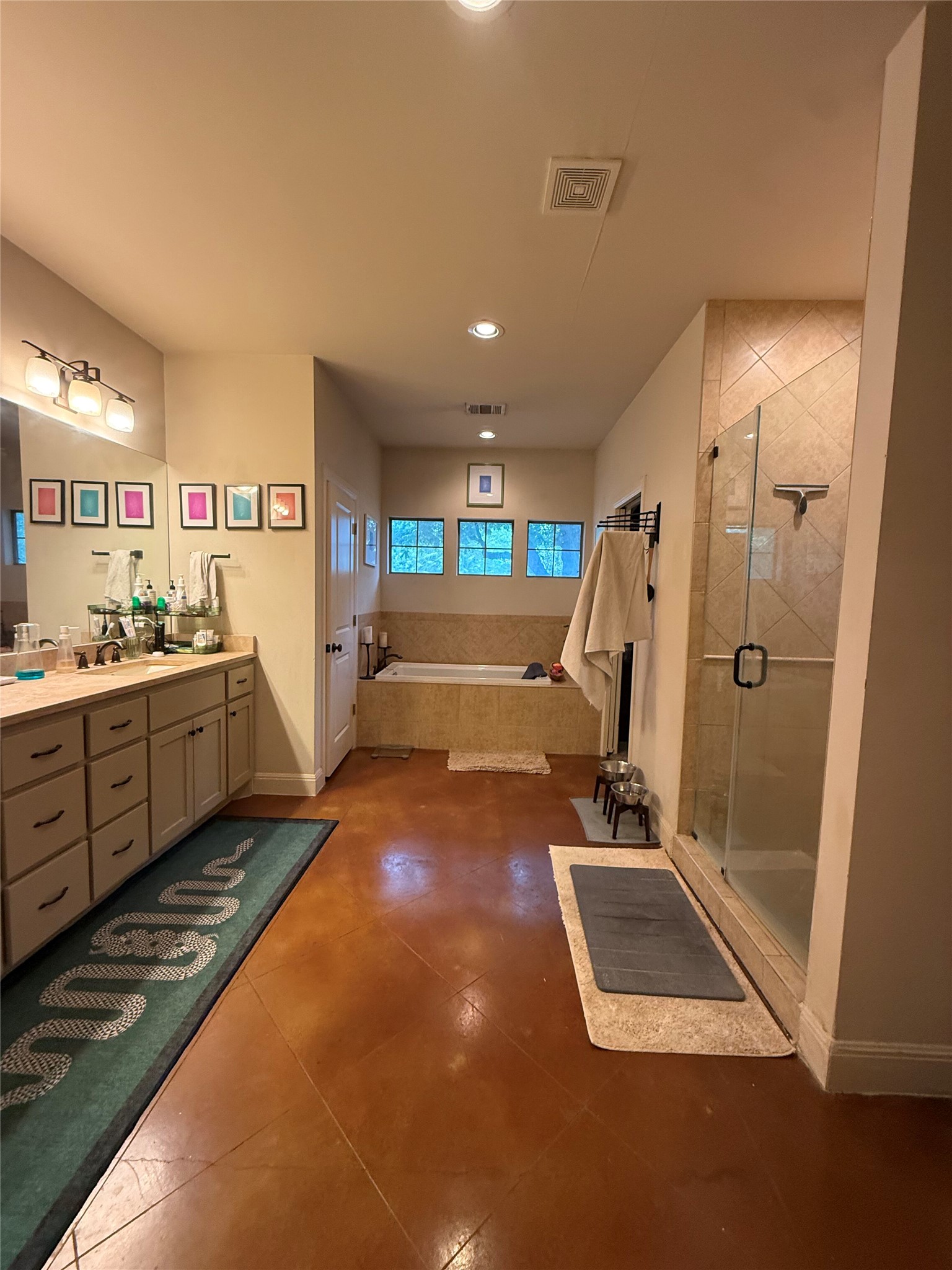 408 West Croslin Street Austin, TX 78752 - Photo 9 of 29 Indulge in a tranquil retreat featuring a spacious soaking tub and a sleek, glass-enclosed shower.