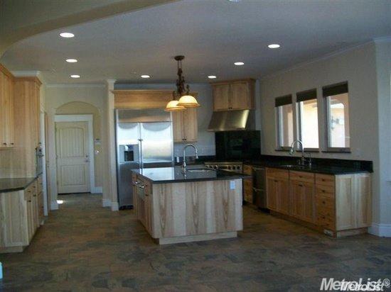 20552 Buchanan Hollow Road, Unit 1 Le Grand, CA 95333 - Photo 11 of 26 a kitchen with stainless steel appliances granite countertop a sink a stove and a refrigerator