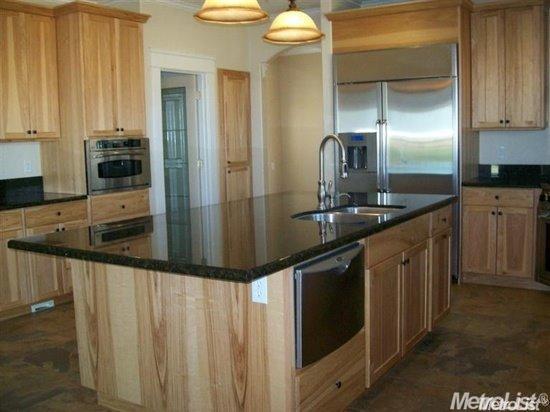 20552 Buchanan Hollow Road, Unit 1 Le Grand, CA 95333 - Photo 12 of 26 a kitchen with stainless steel appliances granite countertop a sink and a refrigerator