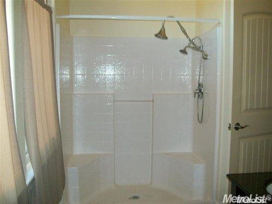20552 Buchanan Hollow Road, Unit 1 Le Grand, CA 95333 - Photo 20 of 26 a bathroom with a glass shower door