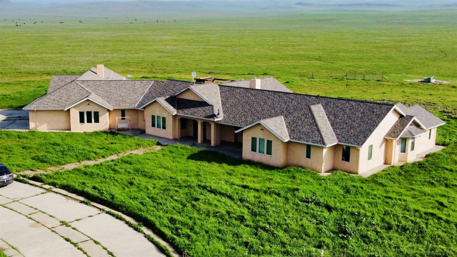 20552 Buchanan Hollow Road, Unit 1 Le Grand, CA 95333 - Photo 2 of 26 an aerial view of a house with a garden and lake view