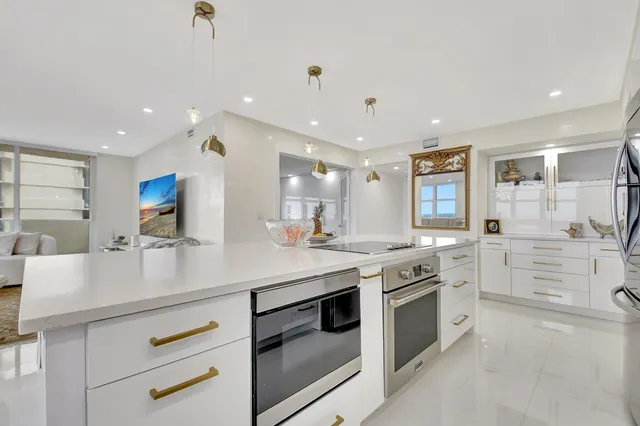 a kitchen with a stove a sink and cabinets