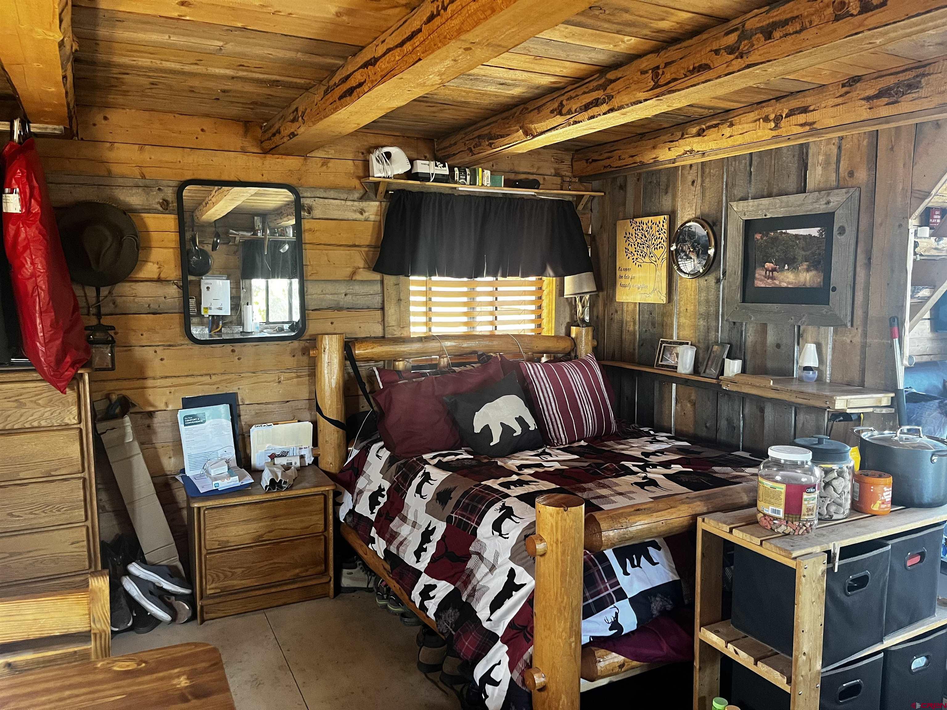 1165 Timber Ridge Road Montrose, CO 81403 - Photo 12 of 44 a bed room with a bed and a window