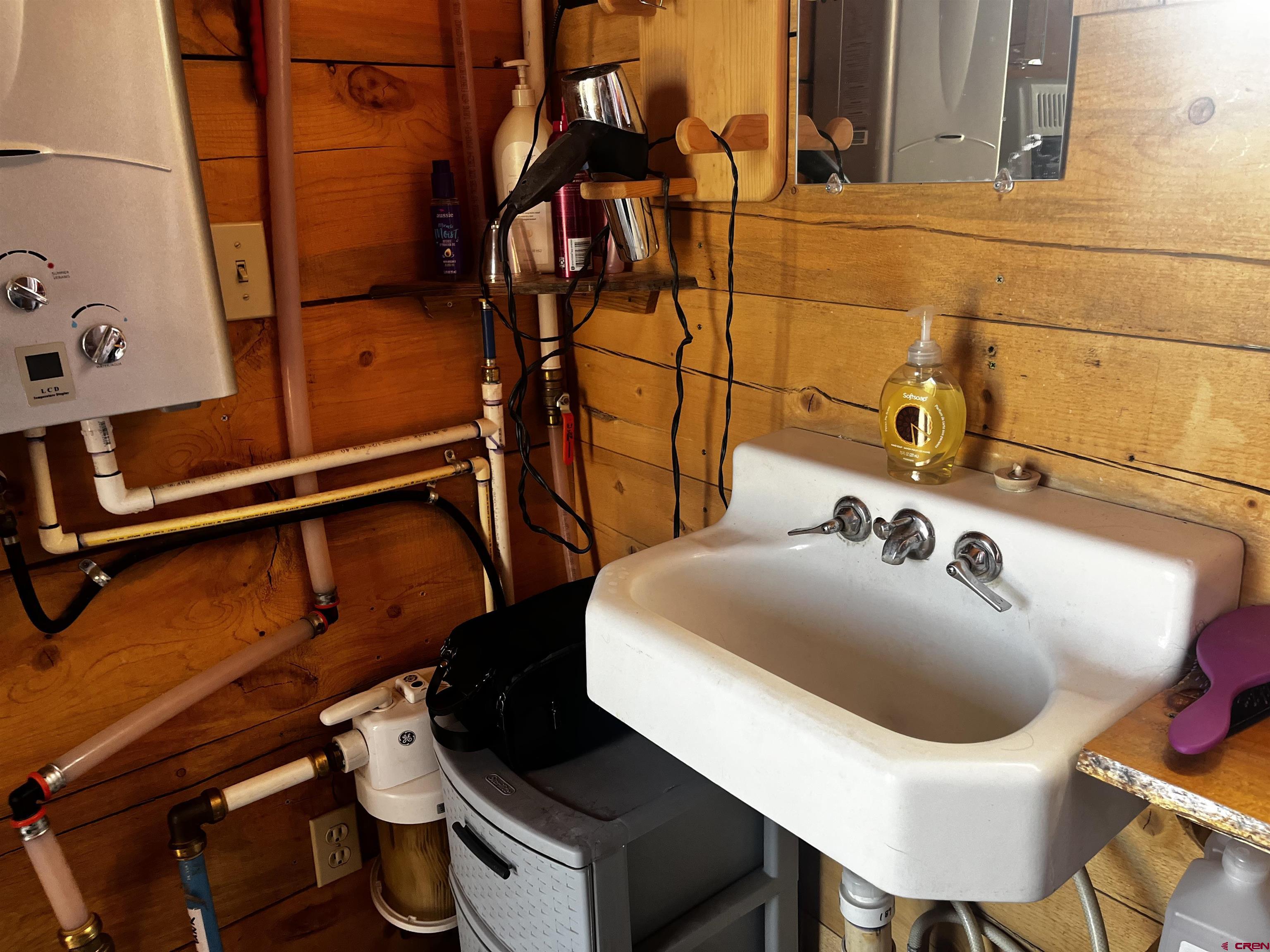 1165 Timber Ridge Road Montrose, CO 81403 - Photo 17 of 44 a bathroom with a sink and mirror