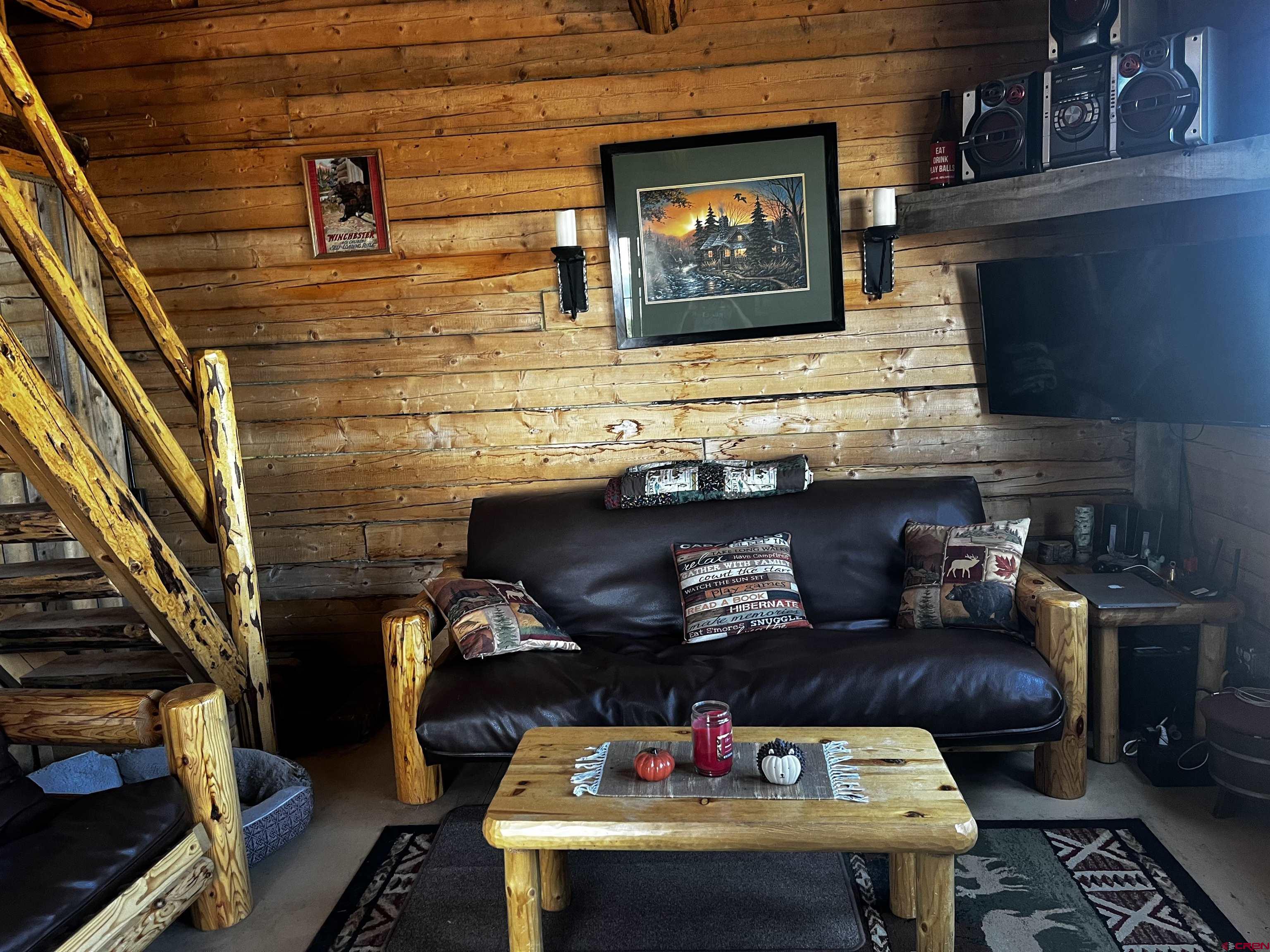 1165 Timber Ridge Road Montrose, CO 81403 - Photo 8 of 44 a room with furniture and a fireplace