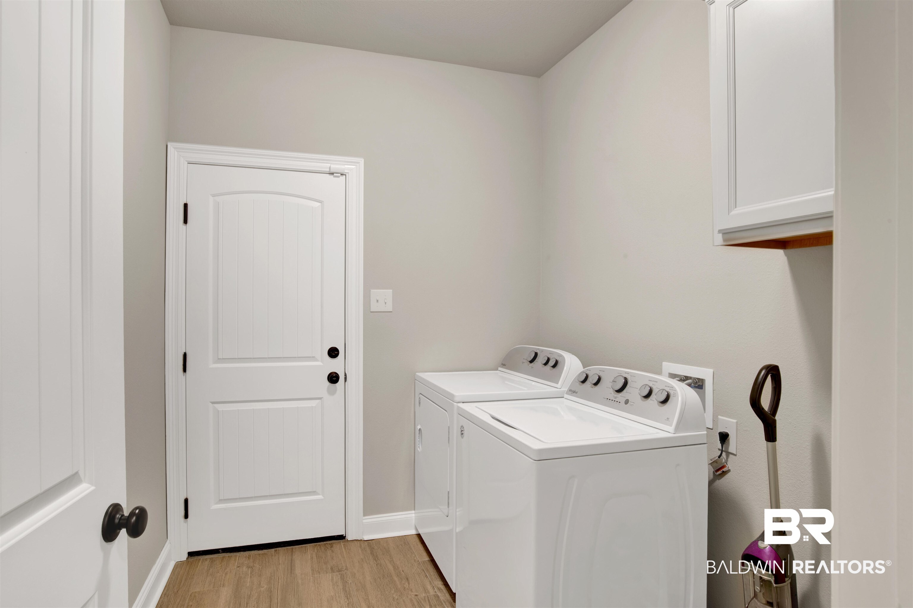 30770 Marcel Boulevard Spanish Fort, AL 36527 - Photo 11 of 23 Laundry room with independent washer and dryer, cabinets, and light hardwood / wood-style flooring