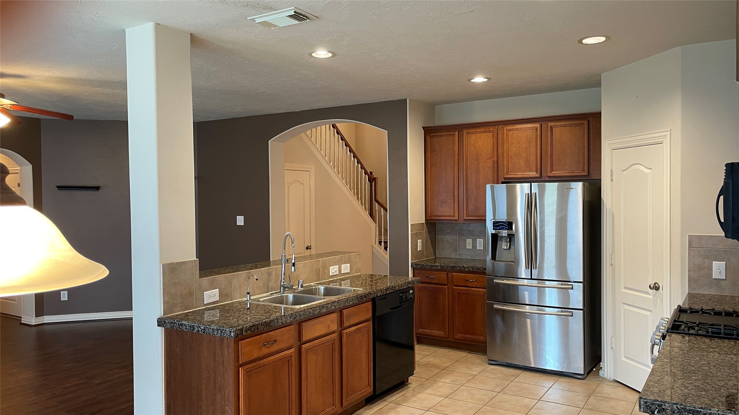 3518 Ewing Drive Manvel, TX 77578 - Photo 14 of 50 a kitchen with stainless steel appliances granite countertop a refrigerator and a sink