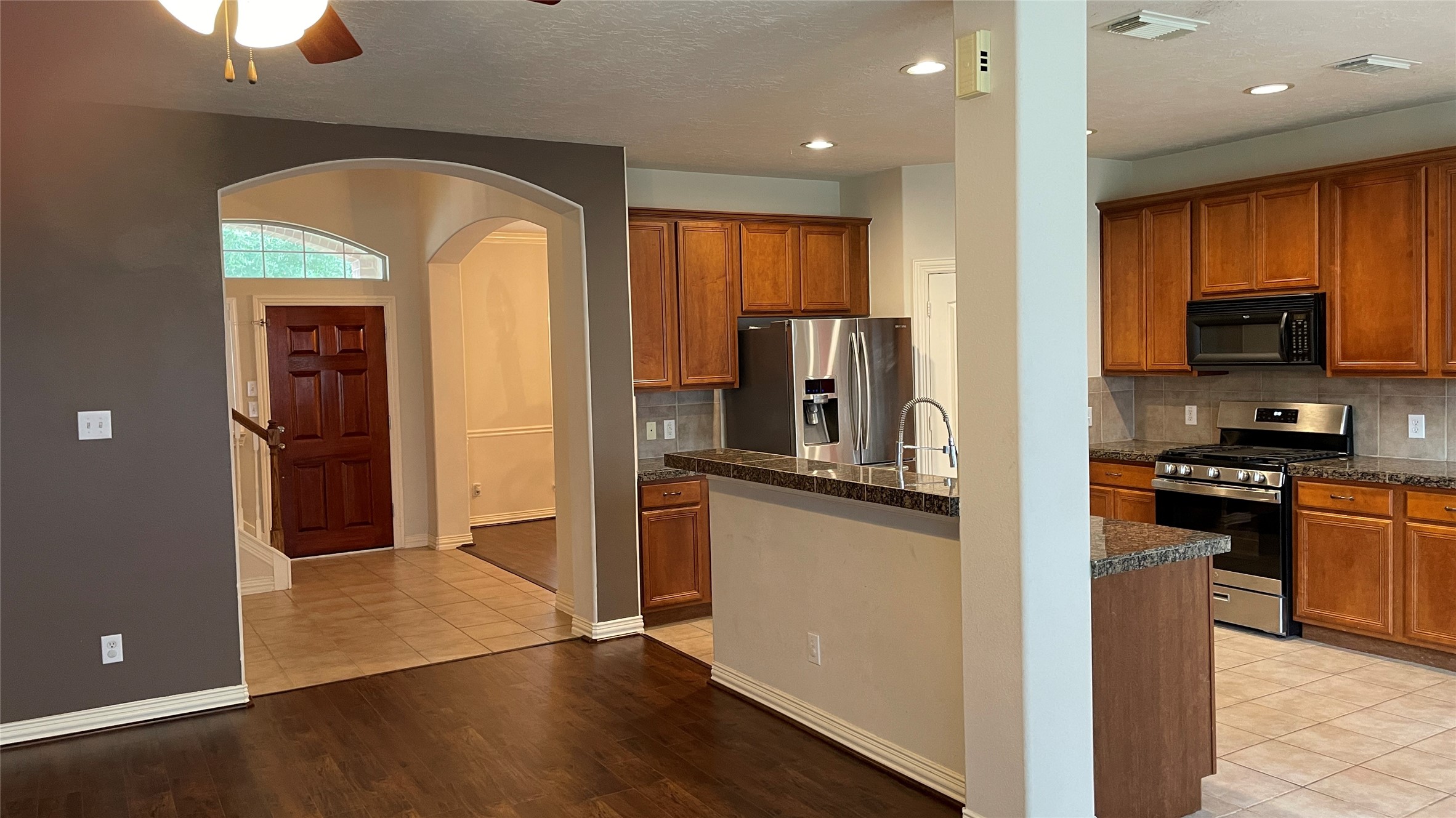 3518 Ewing Drive Manvel, TX 77578 - Photo 8 of 50 a kitchen with stainless steel appliances granite countertop a refrigerator and a stove top oven