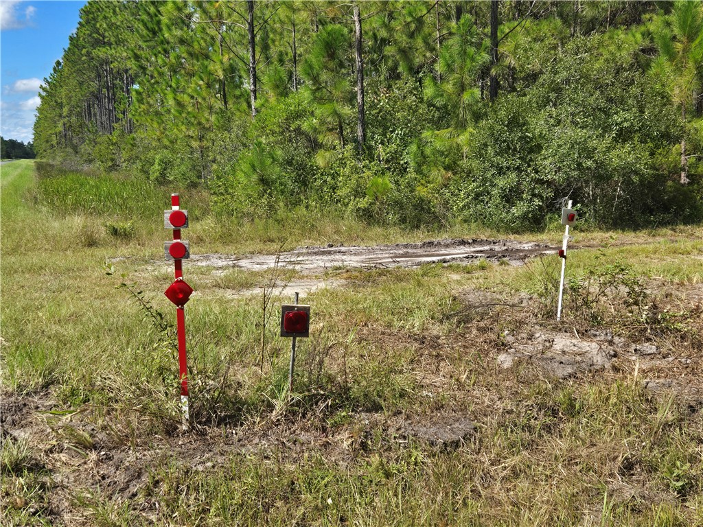 0 Swamp Road Waycross, GA 31503 - Photo 4 of 12 When you see these 2 small posts with red reflectors at a driveway on the right, the concrete landmark with Rayonier on the side is just beyond marking the beginning of the parcel.