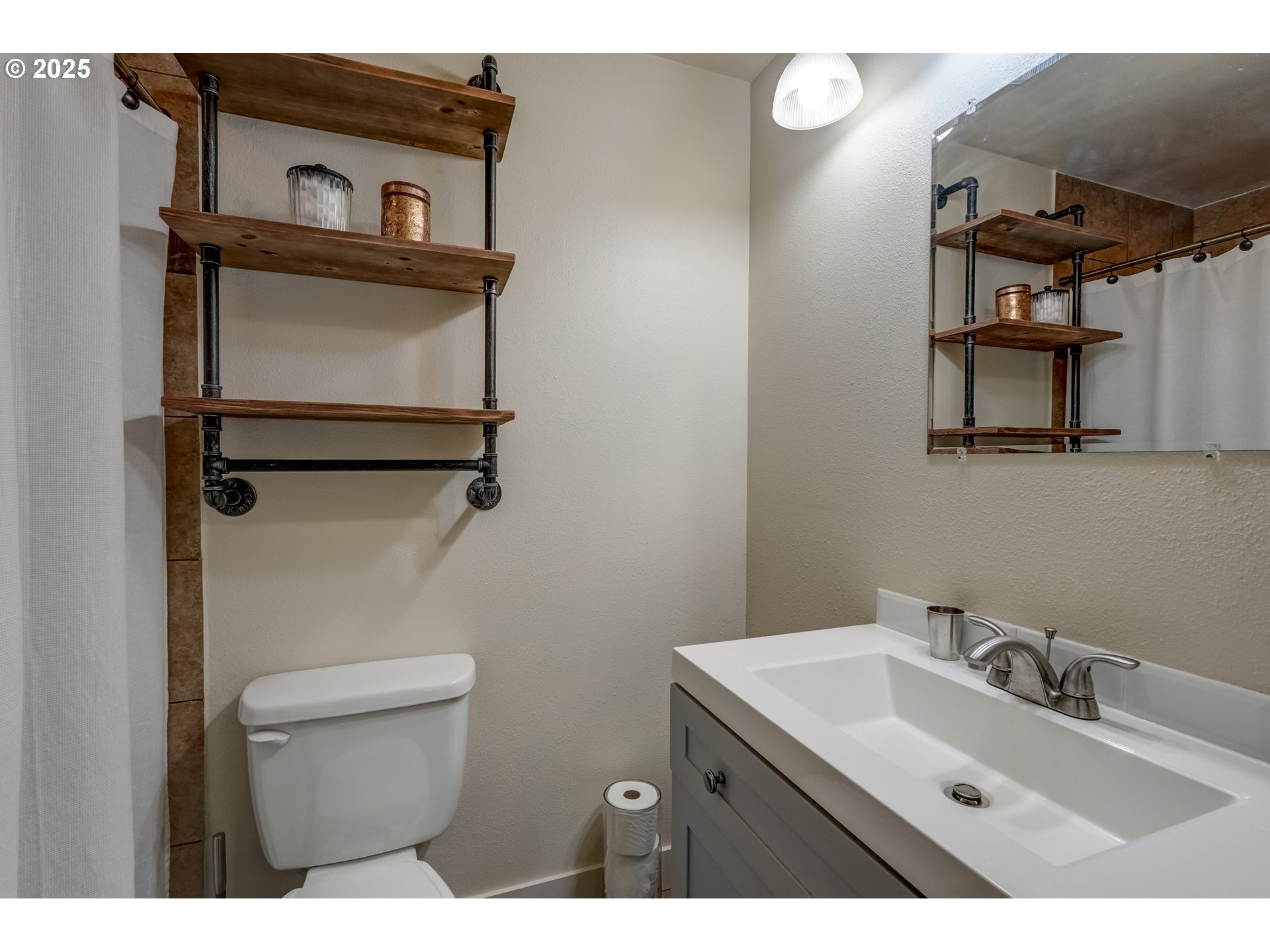 1421 Southwest 6th Place Gresham, OR 97080 - Photo 19 of 27 a bathroom with a sink mirror vanity and toilet