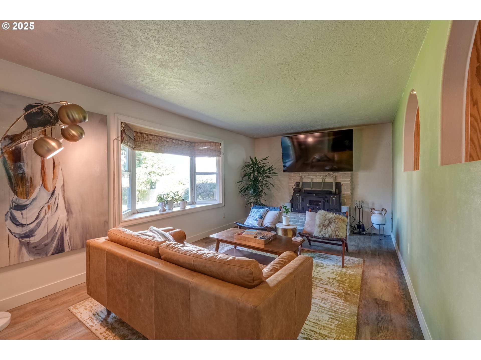 1421 Southwest 6th Place Gresham, OR 97080 - Photo 6 of 27 a living room with furniture a fireplace and a flat screen tv