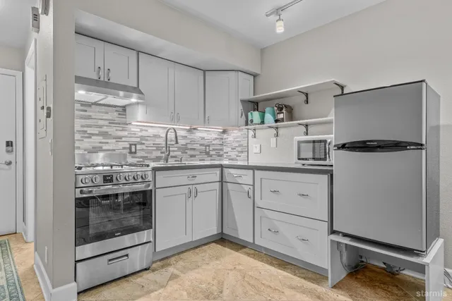 a kitchen with cabinets a sink and stainless steel appliances