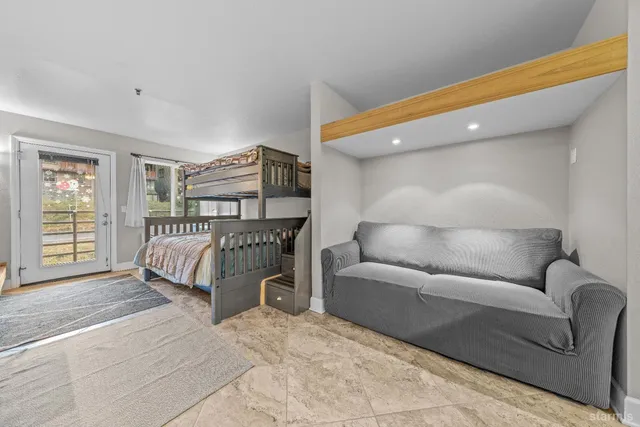 a bedroom with a bed and a window