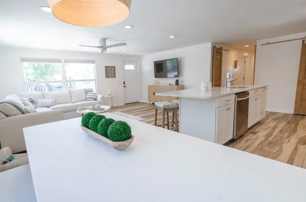 a living room with kitchen island furniture and a fireplace