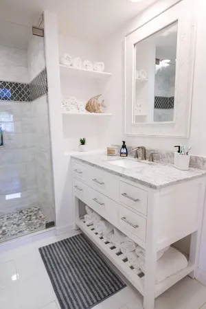 a bathroom with a sink double vanity and a shower