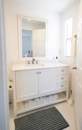 a bathroom with a sink a toilet and a mirror