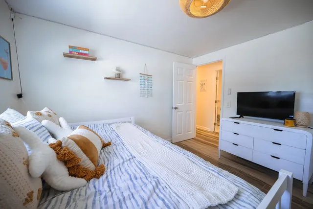 a bedroom with a bed and flat screen tv