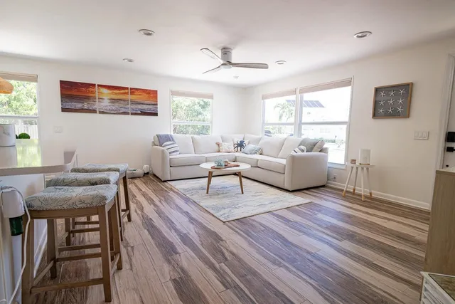 a living room with furniture and a wooden floor