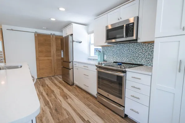 a kitchen with a sink stove and microwave