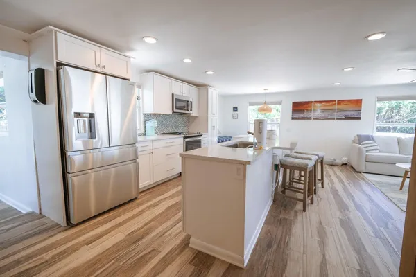 a kitchen with white cabinets and stainless steel appliances