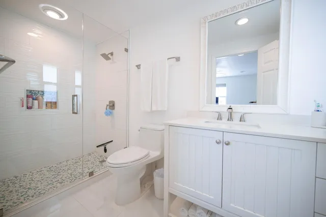 a bathroom with a sink toilet and shower