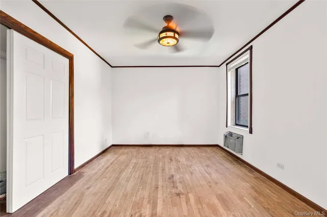 a view of empty room with wooden floor