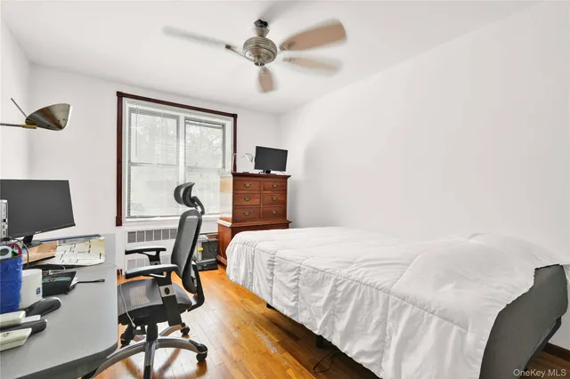 a bedroom with a bed and a desk with chair