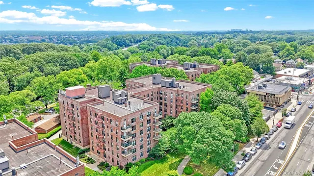 an aerial view of a building with garden space and street view