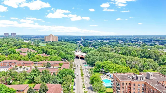 an aerial view of a house with yard and green space