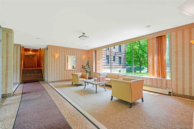 a living room with furniture and large windows