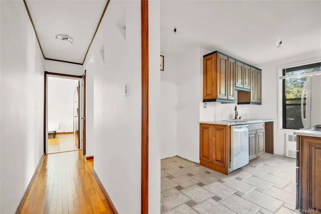 a spacious bathroom with a granite countertop sink a mirror and shower