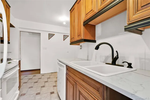 a kitchen with a sink and a refrigerator