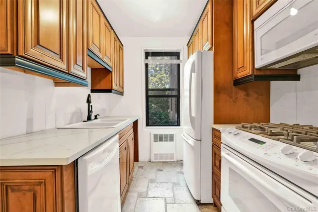 a kitchen with a stove a sink and a refrigerator