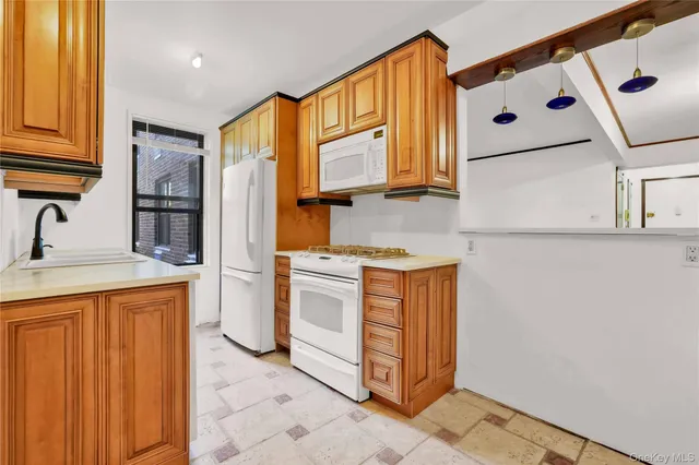 a kitchen with stainless steel appliances granite countertop a sink and a refrigerator
