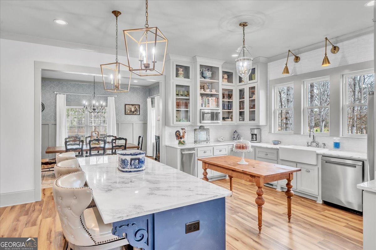 117 Pine Bough Trail Perry, GA 31069 - Photo 13 of 83 a kitchen with stainless steel appliances kitchen island granite countertop a sink and cabinets